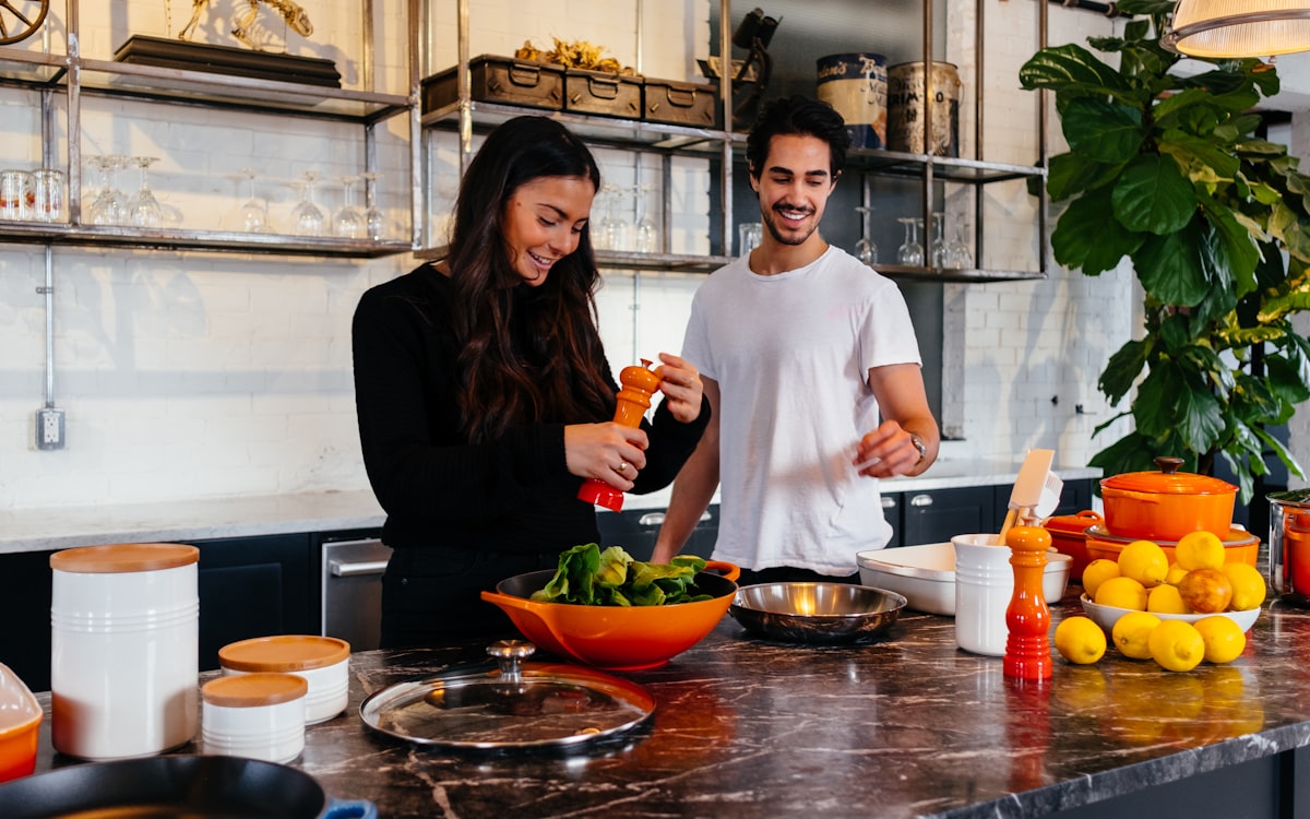 Man and woman standing in front of table
