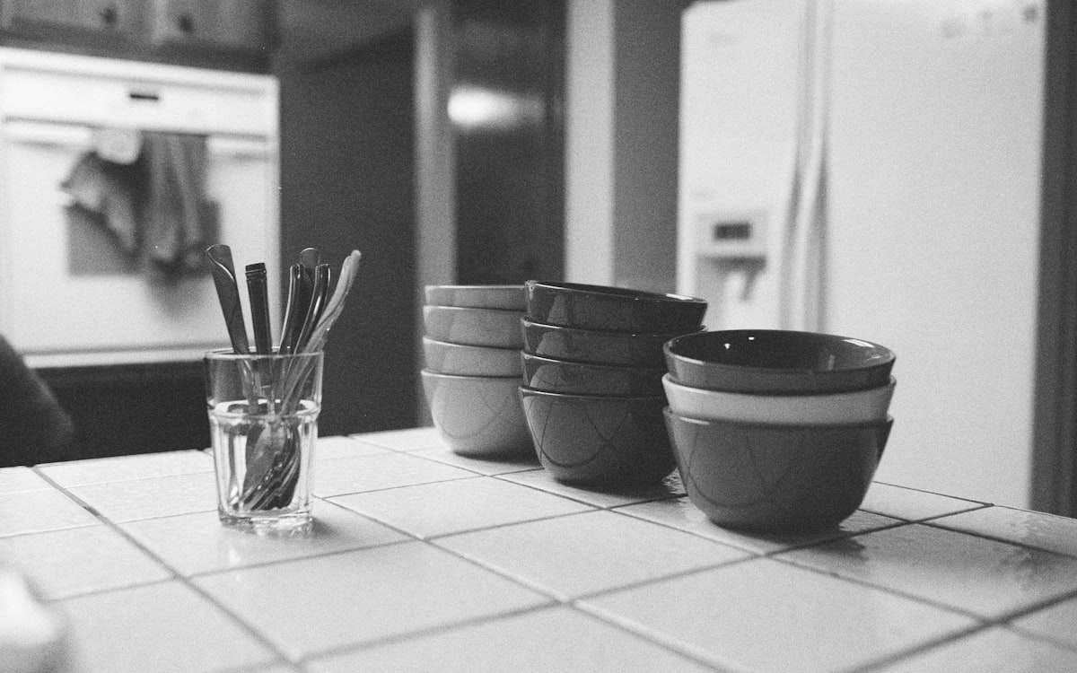 A black and white photo of a kitchen counter