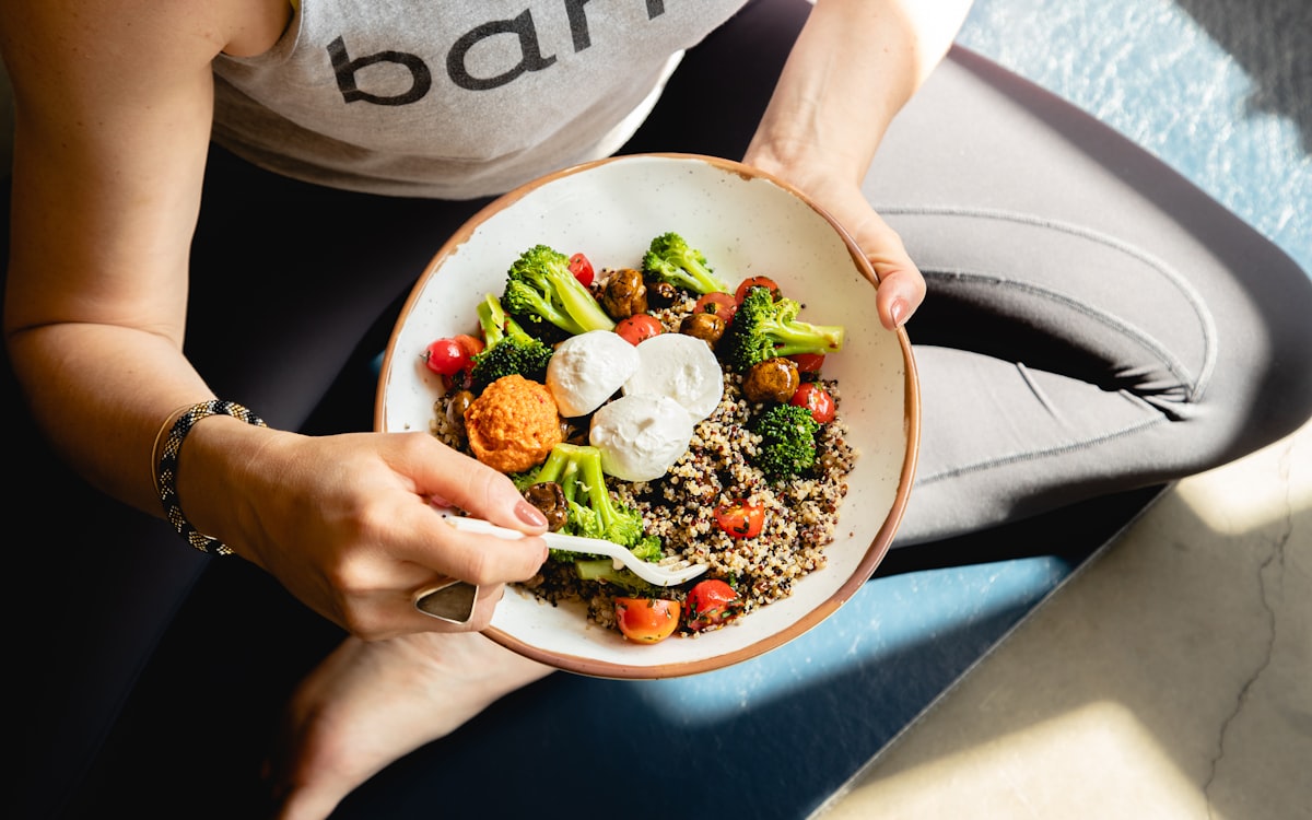 A woman is holding a bowl of food