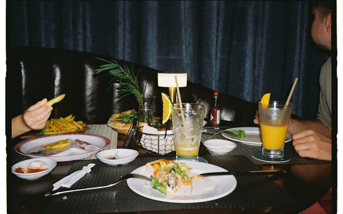 Table with leftover food and drinks after meal