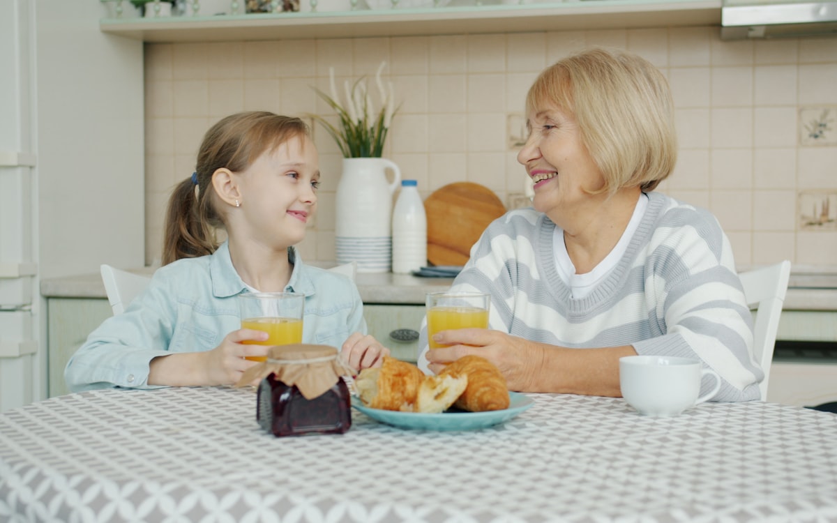 Grandmother and granddaughter enjoying breakfast together