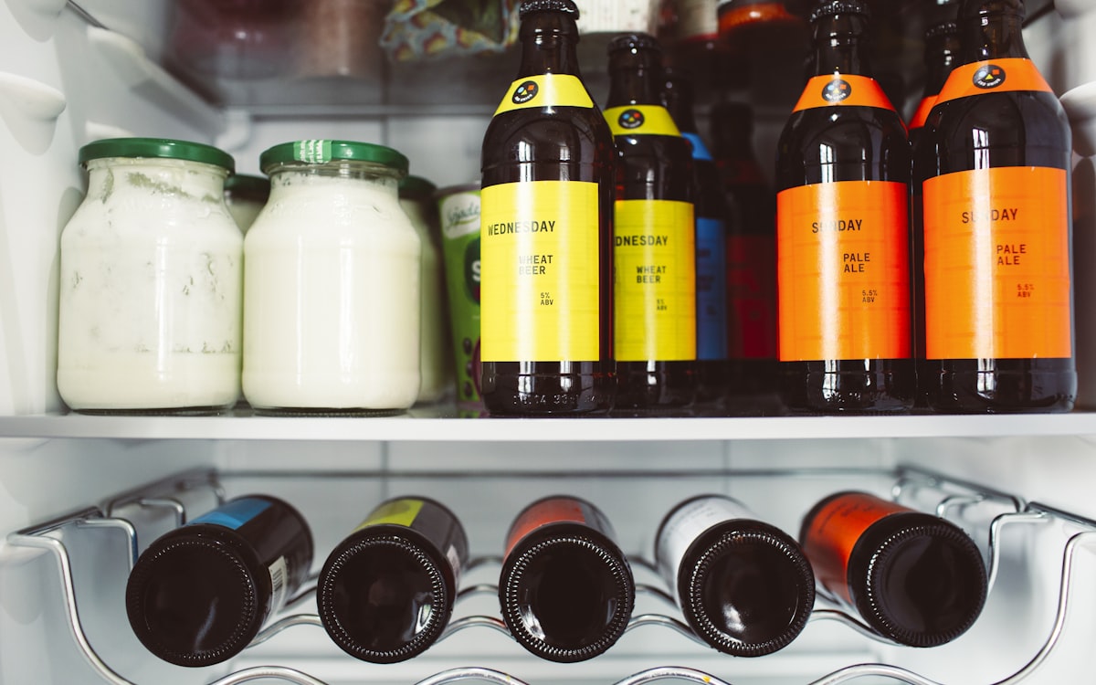 A refrigerator filled with lots of bottles of liquid