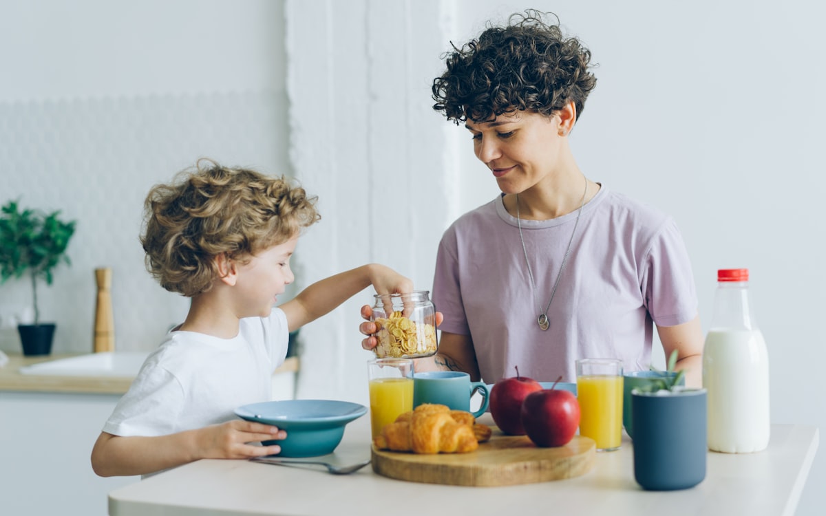 A woman and a child are having breakfast together