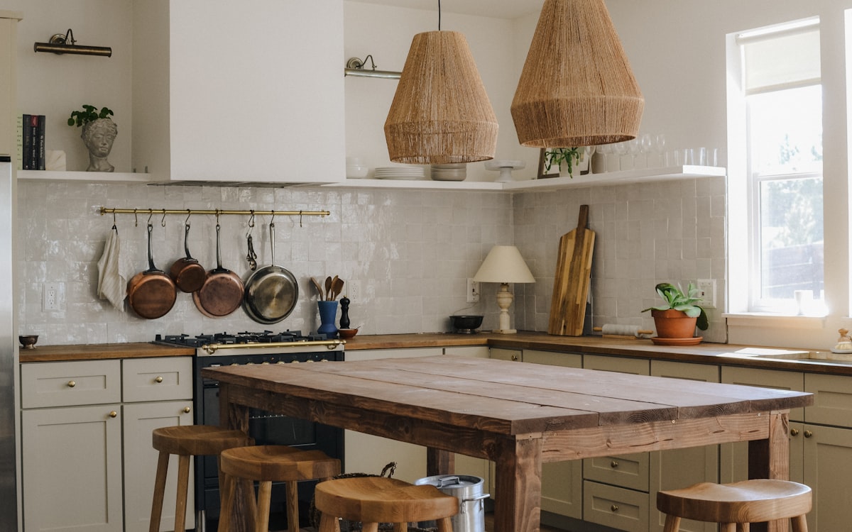Stainless steel cooking pots on white table