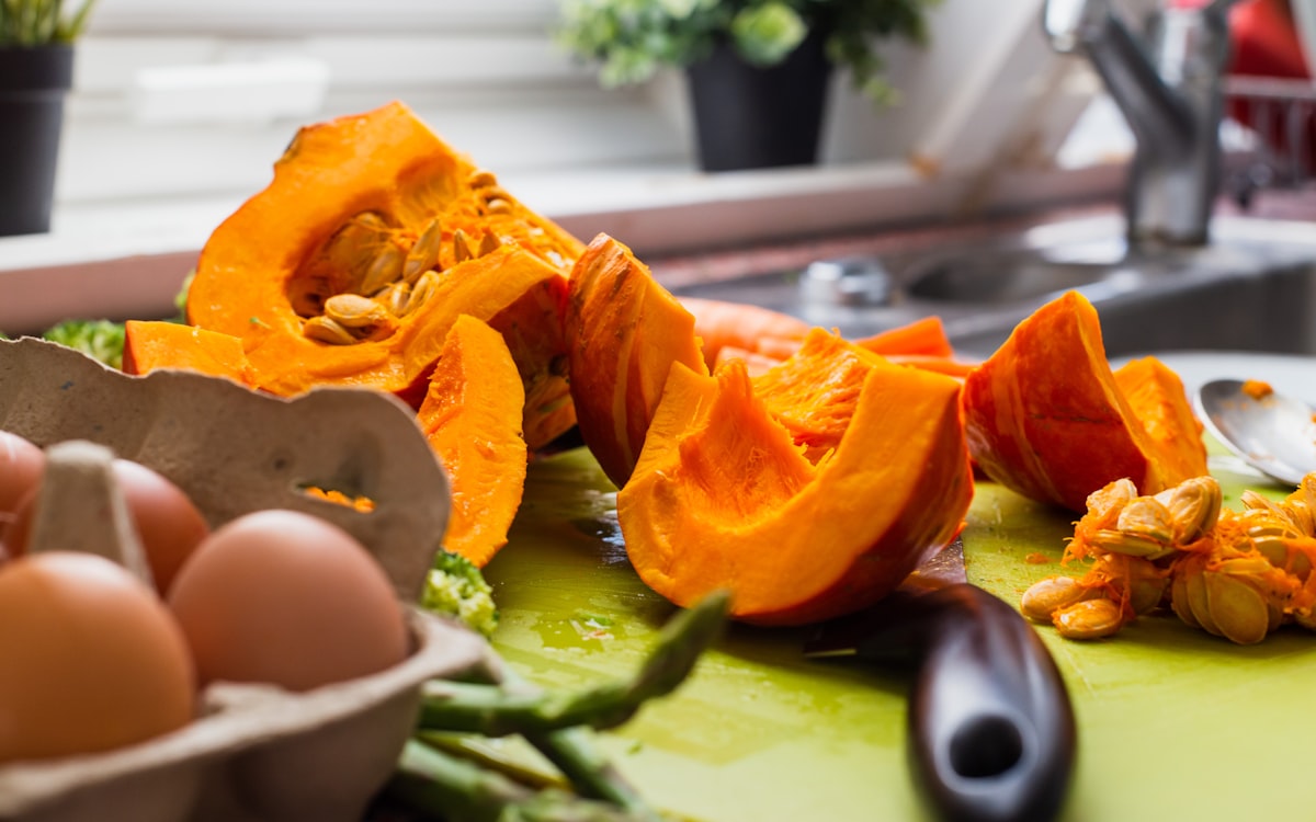 Pumpkin slices near eggs in tray
