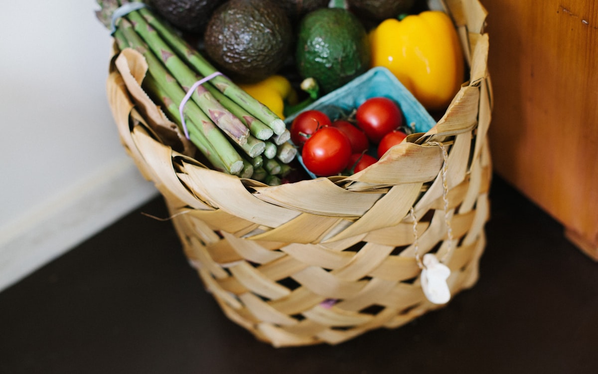 Bunch of assorted produce in brown wicker basket