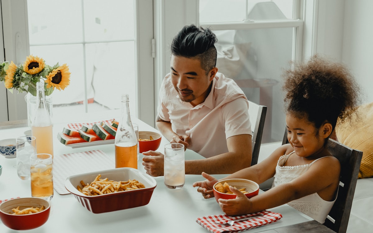 Boy and girl eating on table